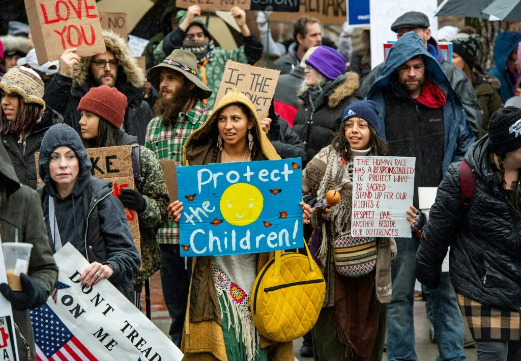Demonstrators protest masks, vaccine mandates and vaccine passports, with some supporting vaccines, at the State House in Boston, Massachusetts on January 5, 2022. (JOSEPH PREZIOSO/AFP via Getty Images)