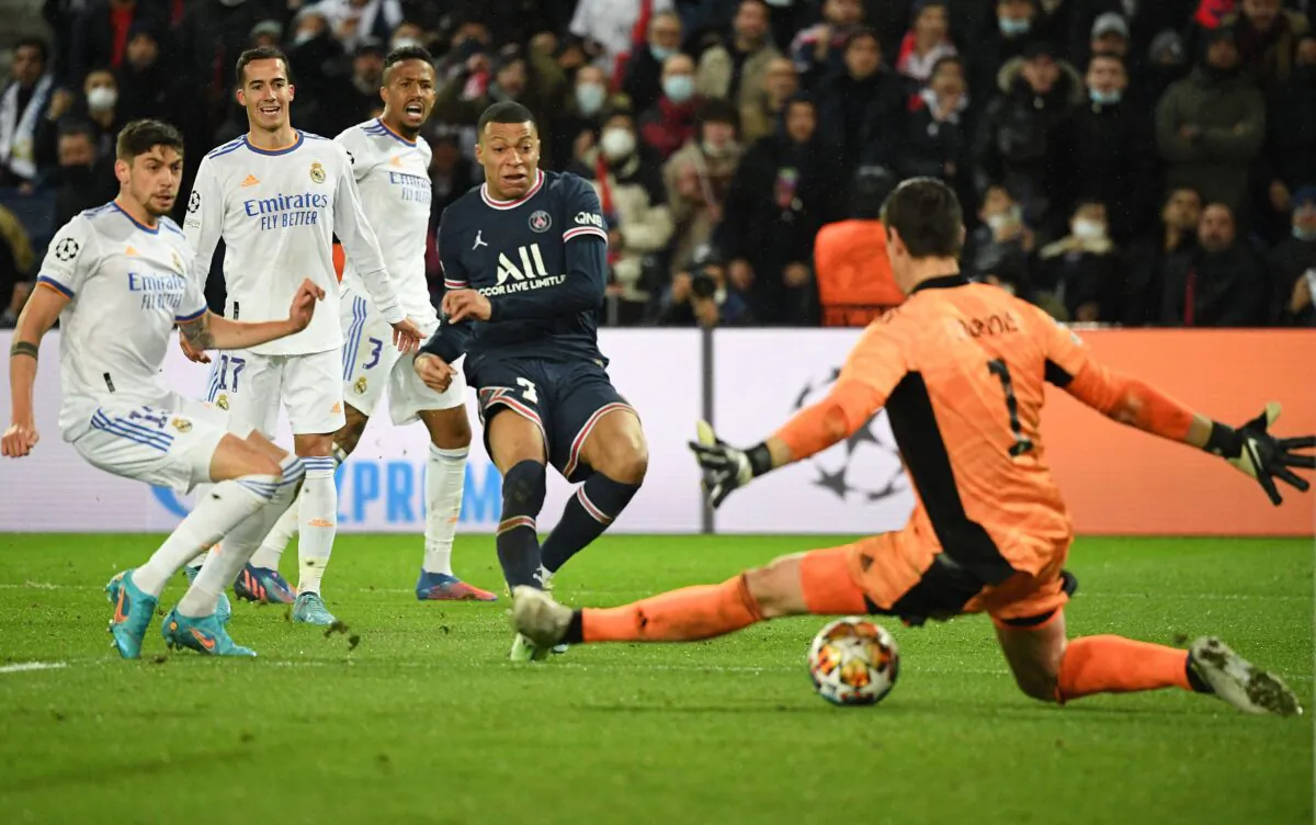 Paris Saint-Germain's French forward Kylian Mbappe (C) shoots and scores a goal during the UEFA Champions League round of 16 first leg football match between Paris Saint-Germain (PSG) and Real Madrid at the Parc des Princes stadium, in Paris, on Feb. 15, 2022. (Alain Jocard/Getty Images)
