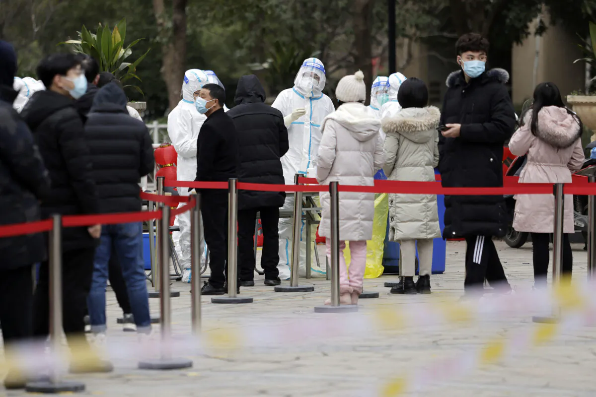 People queue to undergo nucleic acid tests for the COVID-19 in Suzhou, Jiangsu Province, China, on Feb. 16, 2022. (STR/AFP via Getty Images)