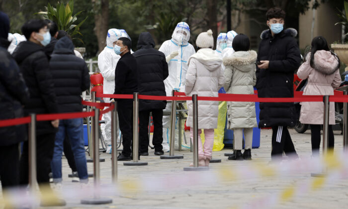 People queue to undergo nucleic acid tests for the COVID-19 in Suzhou, Jiangsu Province, China, on Feb. 16, 2022. (STR/AFP via Getty Images)