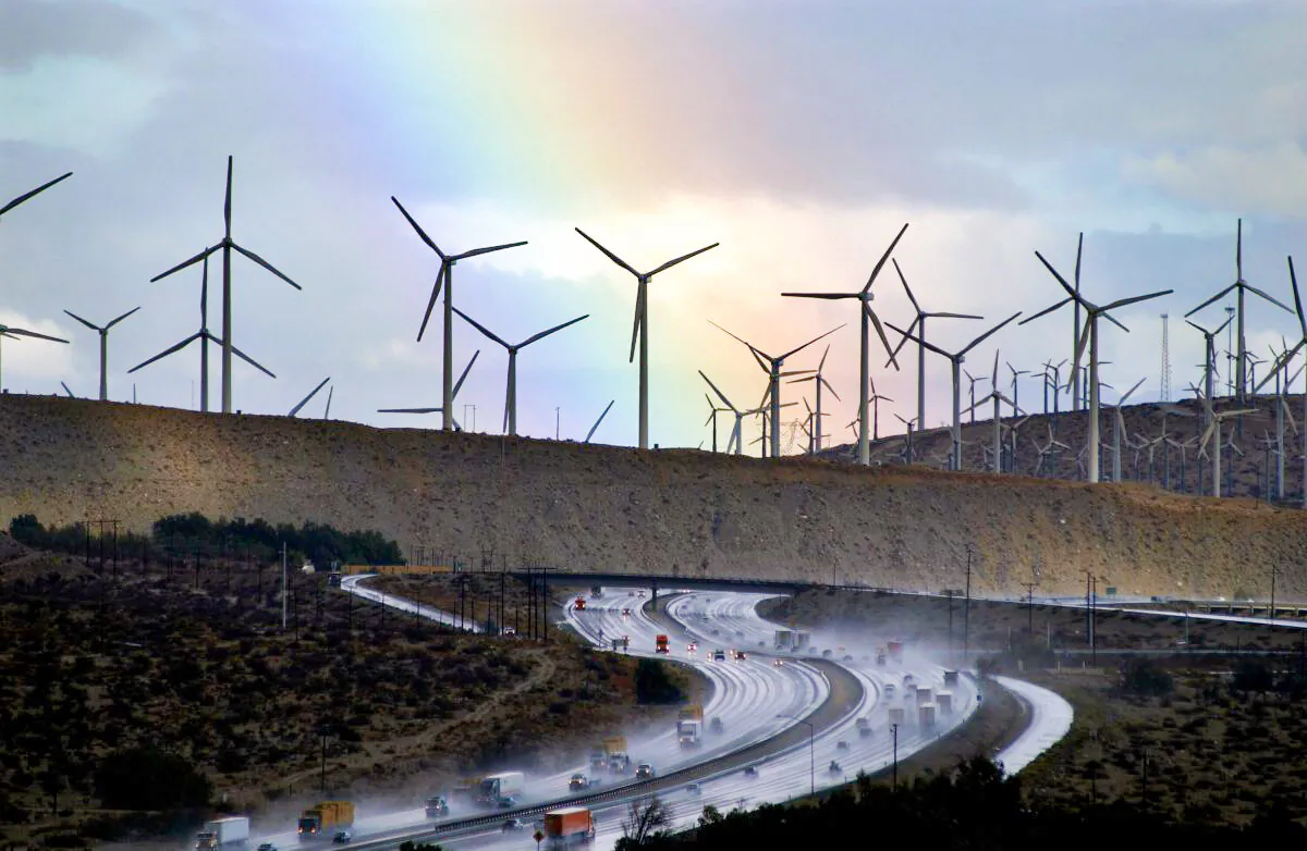 A rainbow forms behind giant windmills near rain-soaked Interstate 10 near Palm Springs, Calif., on on Dec. 17, 2002. (David McNew/Getty Images)