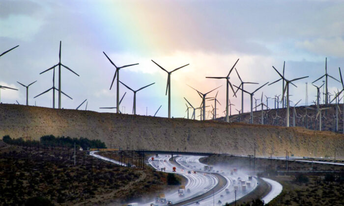A rainbow forms behind giant windmills near rain-soaked Interstate 10 near Palm Springs, Calif., on on Dec. 17, 2002. (David McNew/Getty Images)