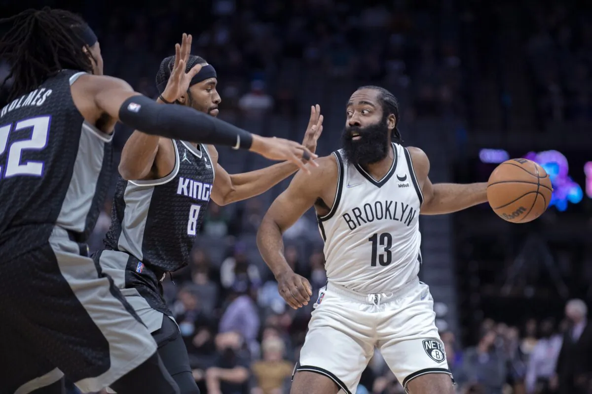 Philadelphia 76ers' James Harden holds up his new jersey after taking questions from the media at a press conference at the NBA basketball team's facility in Camden, N.J. on Feb. 15, 2022. (Chris Szagola/AP Photo)