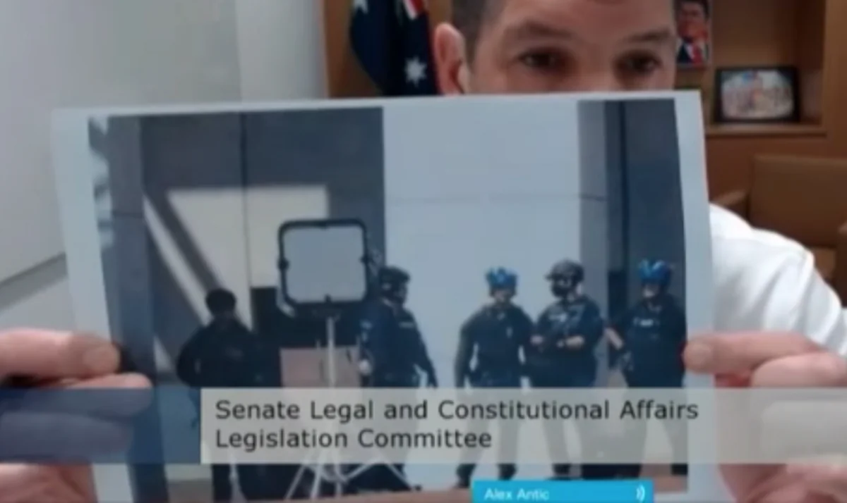 Australian Senator Alex Antic holds up an image of a long range acoustic device that was circulating on social media at a Senate estimates hearing in Canberra, Australia, on Feb. 14, 2022. (Screenshot by The Epoch Times)