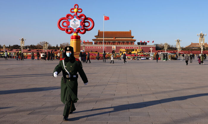 An armed policeman marches through a 17-meter-high flower bed with the theme of "Wonderful Winter Olympics" at Tiananmen Square in Beijing on Jan. 15, 2022. (Lintao Zhang/Getty Images)