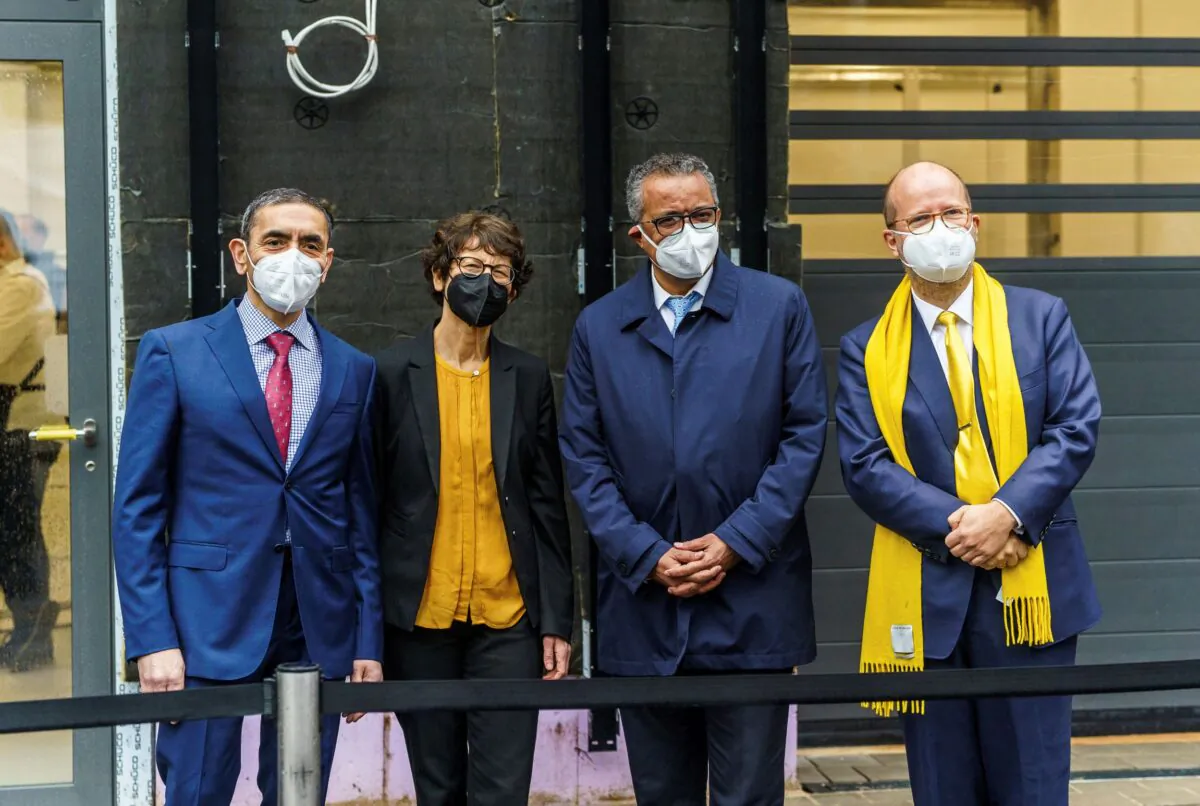 (L–R) Ugur Sahin, BioNTech founder, his wife Ozlem Tureci, co-founder and Chief Medical Officer of BioNTech, Tedros Adhanom Ghebreyesus, Director General of the World Health Organization WHO, and Holm Keller, Executive Chairman of the kENUP Foundation, stand together during the presentation of manufacturing facilities in Marburg, Germany, on Feb. 16, 2022. (Andreas Arnold/dpa via AP)