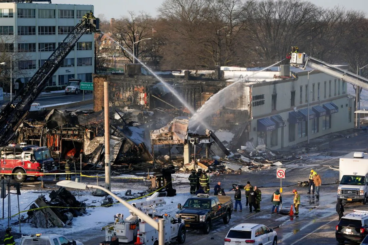 Emergency personnel work at the site of a gas tanker accident in Rockville Centre, N.Y., on Feb. 16, 2022. (Seth Wenig/AP Photo)