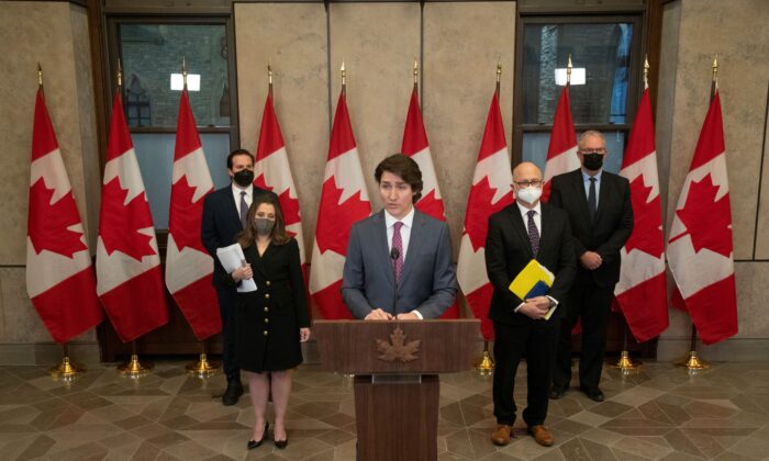 Prime Minister Justin Trudeau, flanked by cabinet ministers including Deputy Prime Minister Chrystia Freeland, announces that the Emergencies Act will be invoked to deal with protests, in Ottawa on Feb. 14, 2022.  (The Canadian Press/Adrian Wyld)