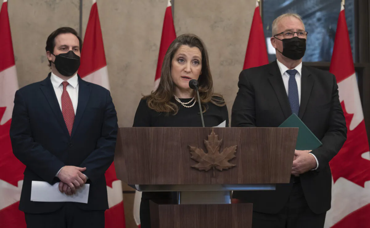 Public Safety Minister Marco Mendicino and President of the Queen's Privy Council for Canada and Emergency Preparedness Minister Bill Blair look on as Deputy Prime Minister and Finance Minister Chrystia Freeland speaks about the implementation of the Emergencies Act, Feb. 17, 2022 in Ottawa.  (The Canadian Press/Adrian Wyld)