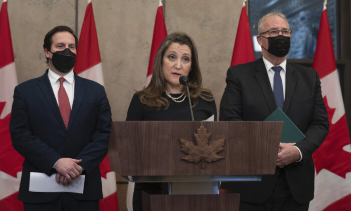 Public Safety Minister Marco Mendicino and President of the Queen's Privy Council for Canada and Emergency Preparedness Minister Bill Blair look on as Deputy Prime Minister and Finance Minister Chrystia Freeland speaks about the implementation of the Emergencies Act, Feb. 17, 2022 in Ottawa.  (The Canadian Press/Adrian Wyld)