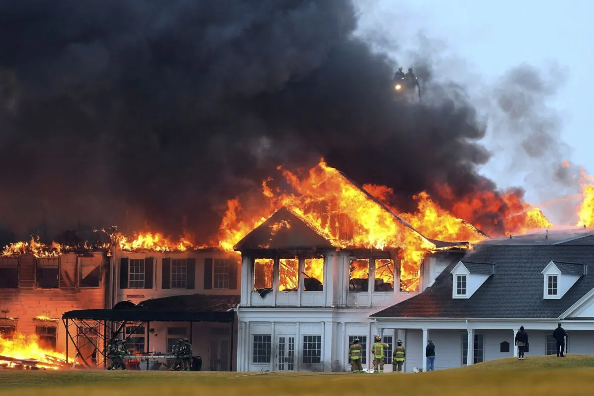 A fire burns at the main building at Oakland Hills Country Club in Bloomfield Township, Mich., on Feb. 17, 2022. (Daniel Mears /Detroit News via AP)