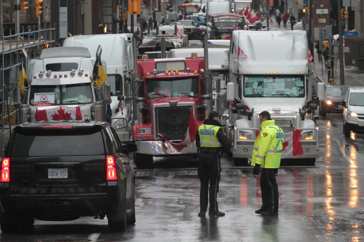 There is an increased police presence in and around the blockaded section of central Ottawa on Feb. 17, 2022. (Richard Moore/The Epoch Times)