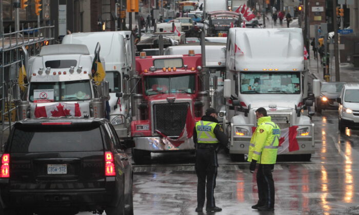 There is an increased police presence in and around the blockaded section of central Ottawa on Feb. 17, 2022. (Richard Moore/The Epoch Times)