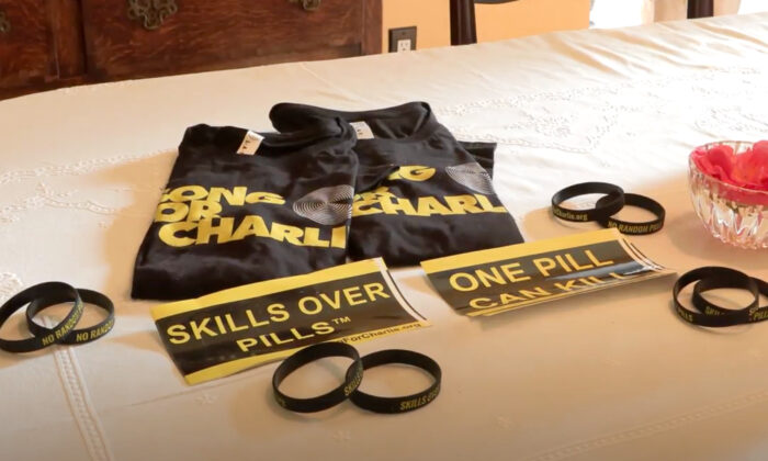 Shirts and wristbands for the organization “Song for Charlie” displayed on a table on Feb. 1, 2022. (Annie Wang/NTD Television)