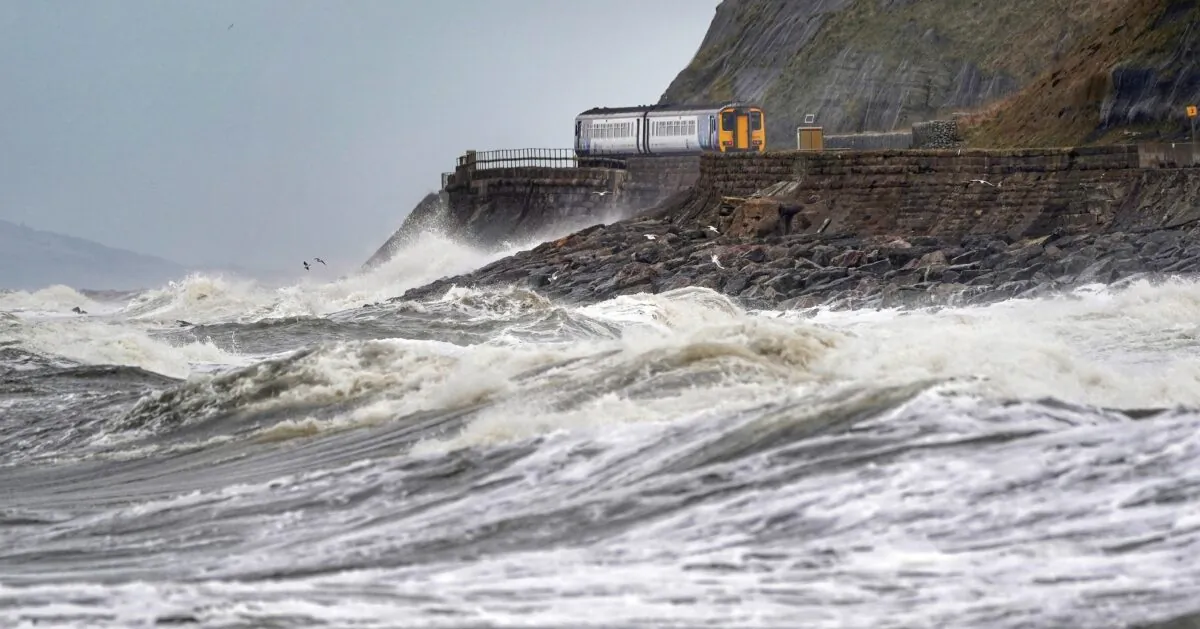 The day after Storm Dudley hit the north of England, a train heads along the west coast between Whitehaven and Carlisle country, on Feb. 17, 2022. (Owen Humphreys/PA)