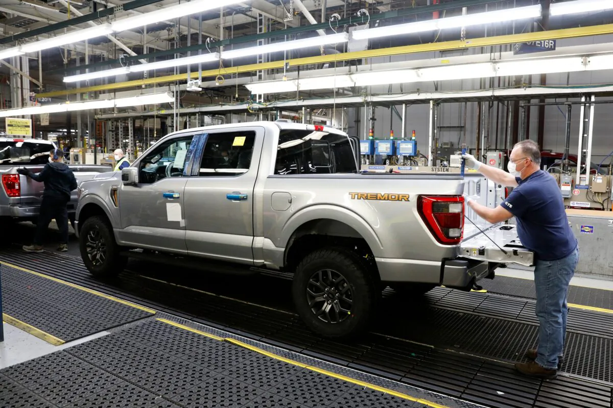 An employee works on a Ford Motor Co. F-Series truck on the assembly line at the Ford Dearborn Truck Plant in Dearborn, Mich., on Jan. 26, 2022. (Jeff Kowalsky/AFP via Getty Images)