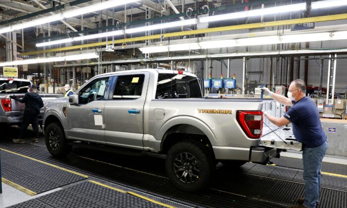 An employee works on a Ford Motor Co. F-Series truck on the assembly line at the Ford Dearborn Truck Plant in Dearborn, Mich., on Jan. 26, 2022. (Jeff Kowalsky/AFP via Getty Images)