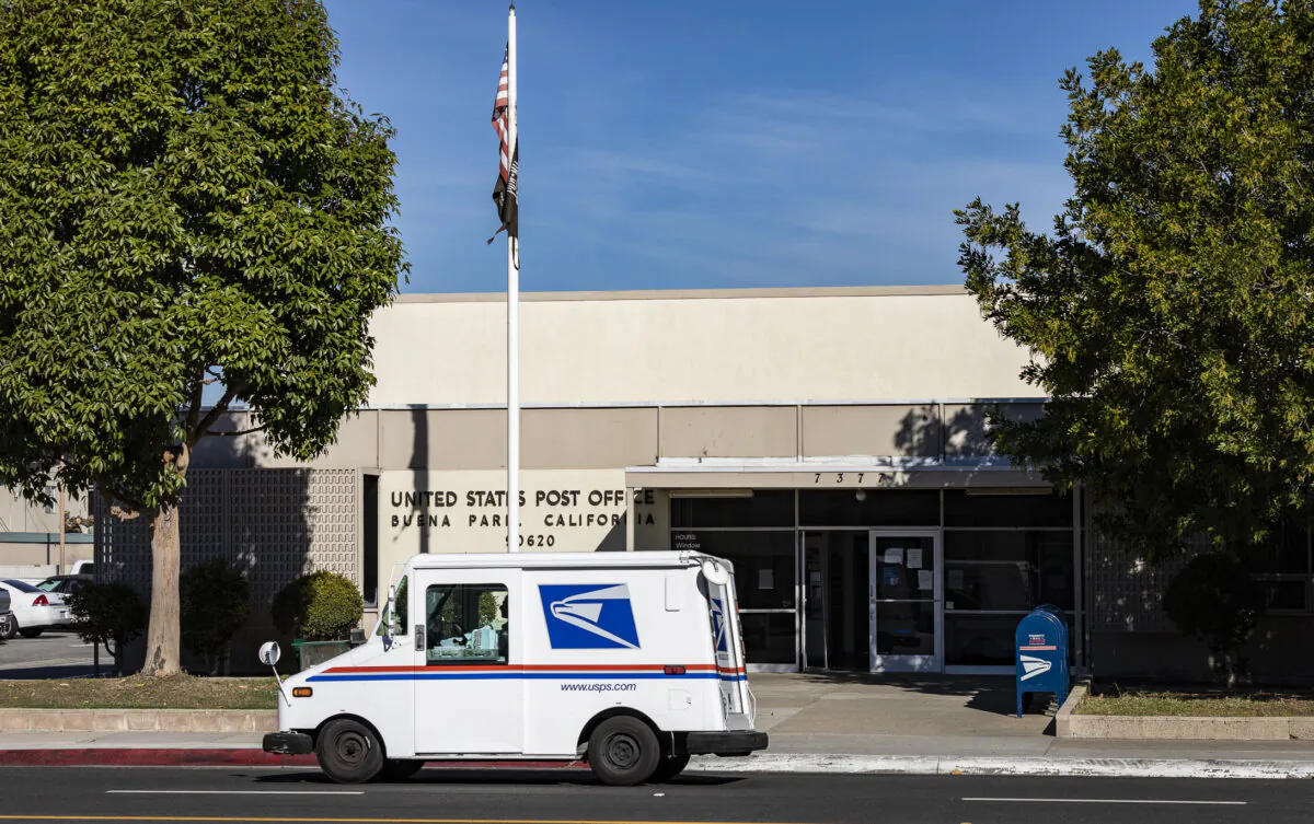 A mail carrier parks in front of a USPS building in Buena Park, Calif., on Jan. 15, 2021. (John Fredricks, The Epoch Times)