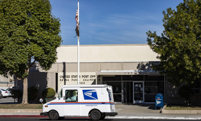 A mail carrier parks in front of a USPS building in Buena Park, Calif., on Jan. 15, 2021. (John Fredricks, The Epoch Times)
