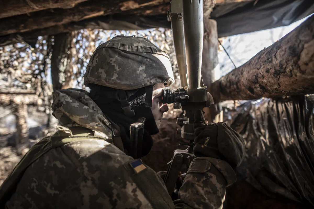 A Ukrainian serviceman watches pro-Russian separatist positions near the village of Svitlodarsk, Ukraine, on Feb. 14, 2022. (Manu Brabo/Getty Images)
