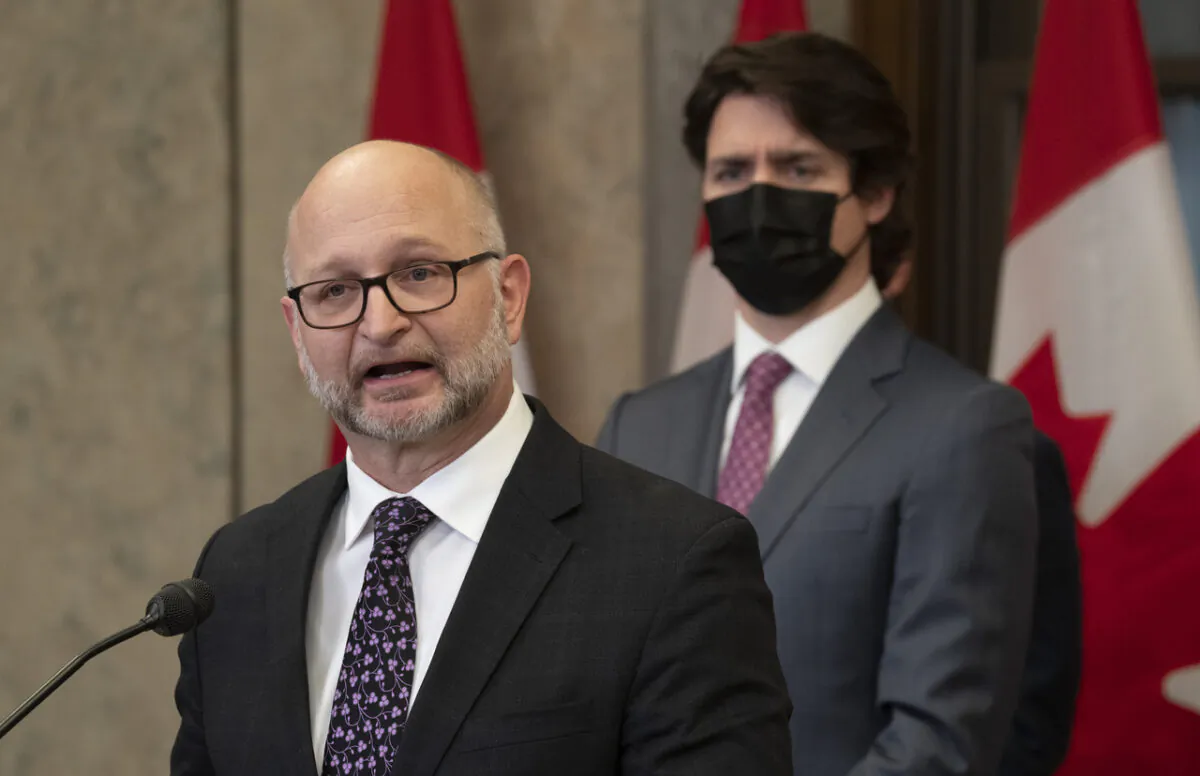 Canadian Prime Minister Justin Trudeau looks on as Minister of Justice and Attorney General of Canada David Lametti speaks following the announcement of the Emergencies Act invoked to deal with the protest in Ottawa against federal COVID-19 mandates on Feb. 14, 2022. (Adrian Wyld/The Canadian Press)