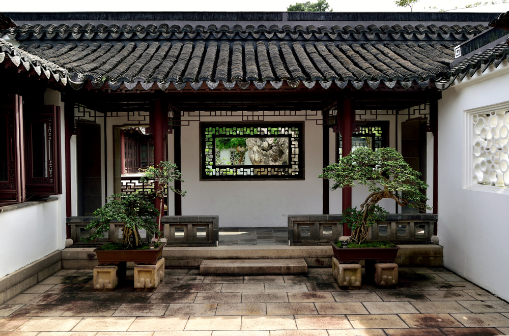A traditional Chinese courtyard with decorative Bonsai plants and classical windows at the Chinese Gardens, Singapore. (Justin Adam Lee/ Shutterstock)