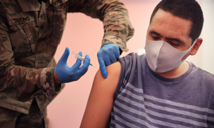 A man gets vaccinated in Wheaton, Md., in a file image. (Chip Somodevilla/Getty Images)