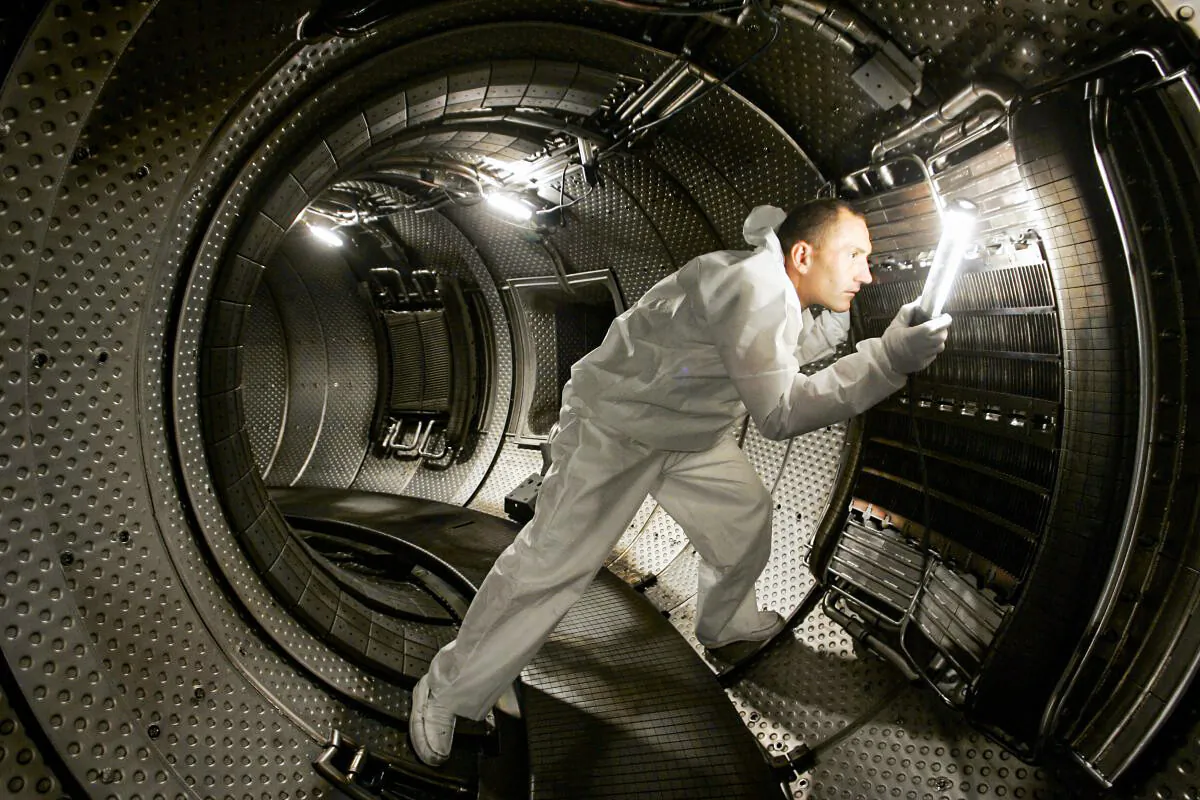 A technician checks a plasma heating system inside a chamber of a nuclear reactor in this file photo in Cadarache, France, on July 28, 2004. Typical fusion experiments involve a tokamak reactor, but the National Ignition Facility's method of using powerful lasers has successfully produced clean nuclear energy. (Boris Horvat/AFP/Getty Images)