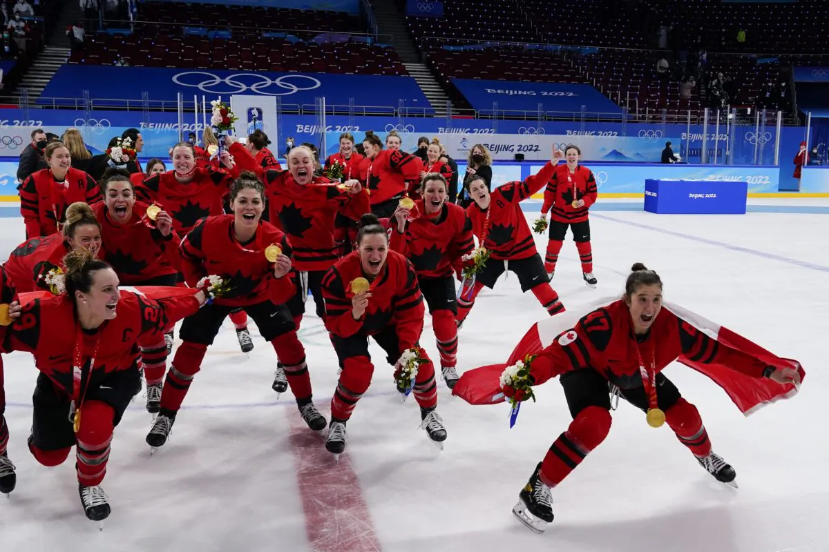 Canada players celebrate with their gold medals after the women's gold medal hockey game at the 2022 Winter Olympics, in Beijing, on Feb. 17, 2022,. (Matt Slocum/AP Photo)