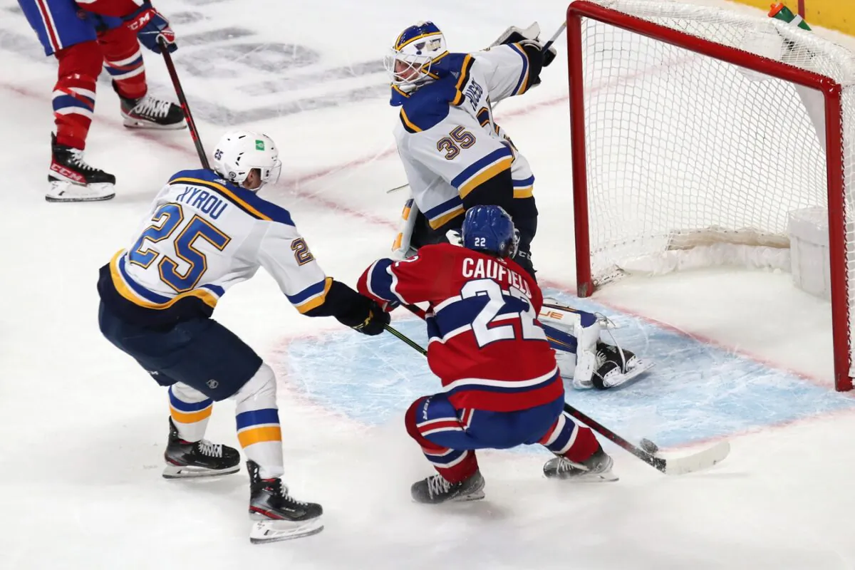 Montreal Canadiens right wing Cole Caufield (22) shoots the puck against St. Louis Blues goaltender Ville Husso (35) during an over time period at Bell Centre in Montreal, on Feb. 17, 2022. (Jean-Yves Ahern/USA TODAY Sports via Field Level Media)