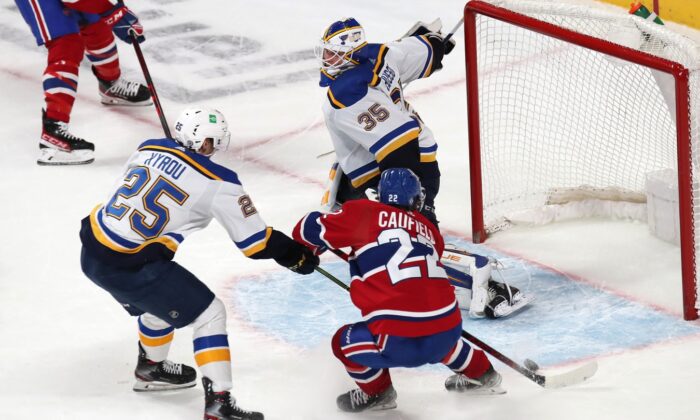 Montreal Canadiens right wing Cole Caufield (22) shoots the puck against St. Louis Blues goaltender Ville Husso (35) during an over time period at Bell Centre in Montreal, on Feb. 17, 2022. (Jean-Yves Ahern/USA TODAY Sports via Field Level Media)