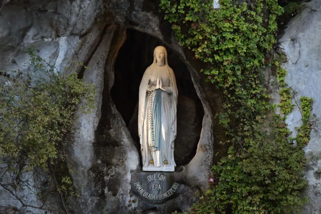Picture shows the statue of the Virgin Mary, inside the Massabielle cave where the Virgin Mary is said to have appeared to Bernadette Soubirous, in the Sanctuary of Our Lady, in Lourdes, France, on Nov. 5, 2019. (Pascal Pavani/AFP via Getty Images)