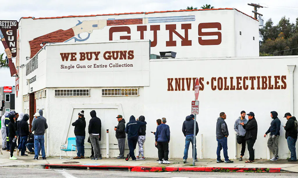 People stand in line outside the Martin B. Retting gun store in Culver City, Calif., on March 15, 2020. (Mario Tama/Getty Images)