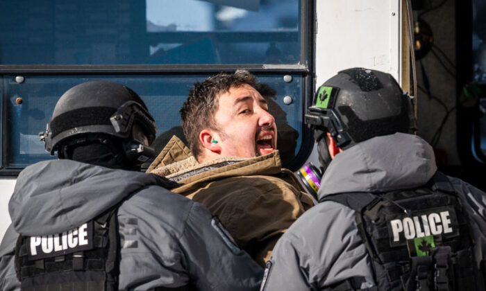 Police arrest a demonstrator against COVID-19 mandates in Ottawa on Feb. 18, 2022. (Andrej Ivanov/AFP) 