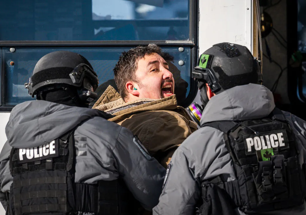 Police arrest a demonstrator against COVID-19 mandates in Ottawa on Feb. 18, 2022. (Andrej Ivanov/AFP) 
