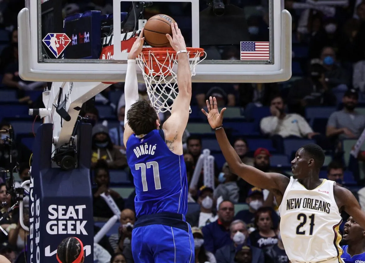 Dallas Mavericks guard Luka Doncic (77) dunks the ball against New Orleans Pelicans forward Tony Snell (21) during the second half at the Smoothie King Center in New Orleans, on Feb. 17, 2022. (Stephen Lew/USA TODAY Sports via Field Level Media)
