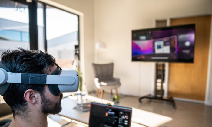 Gavin Menichini, using the Oculus Quest 2 VR headset, gives a demonstration of the Immersed Virtual Reality program which can be used for many applications on Jan. 28, 2022 in Austin, Texas. (Sergio Flores/AFP via Getty Images)
