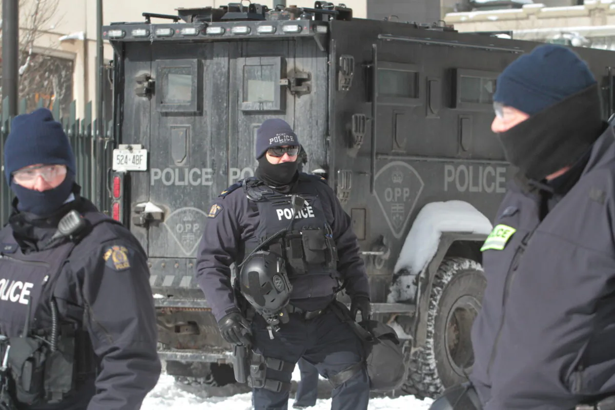 Police officers in Ottawa on Feb. 18, 2022, during Freedom Convoy protest in the capital city. (Richard Moore/The Epoch Times)