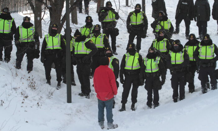 A lone protester confronts police in Ottawa on Feb. 18, 2022. (Richard Moore/The Epoch Times)