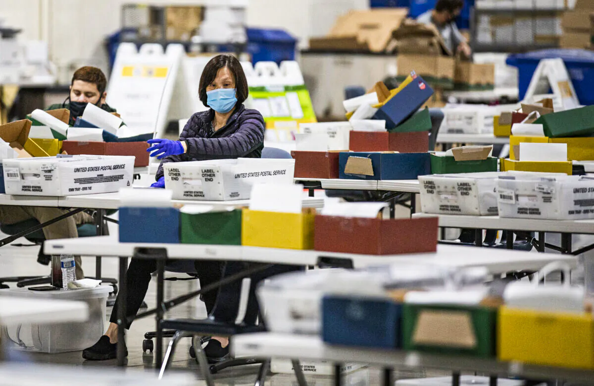 Los Angeles Registrar's Office personnel process mail in voting ballots in Pomona, Calif., on Aug. 31, 2021. (John Fredricks/The Epoch Times)