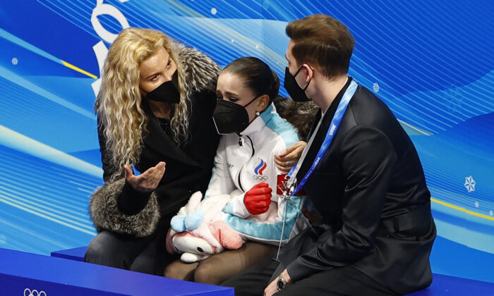 Kamila Valieva (C) of the Russian Olympic Committee reacts with coaches Daniil Gleikhengauz (R) and Eteri Tutberidze (L) after her performance in the women's free skating program during the figure skating competition at the 2022 Winter Olympics in Beijing on Feb. 17, 2022. (Evgenia Novozhenina/Reuters)