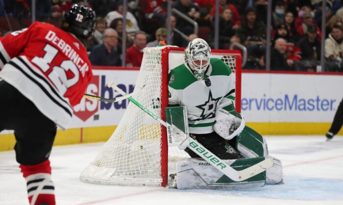 Dallas Stars goaltender Jake Oettinger (29) makes a save on a shot from Chicago Blackhawks left wing Alex DeBrincat (12) during the third period at the United Center in Chicago, on Feb. 18, 2022. (Dennis Wierzbicki/USA TODAY Sports via Field Level Media)