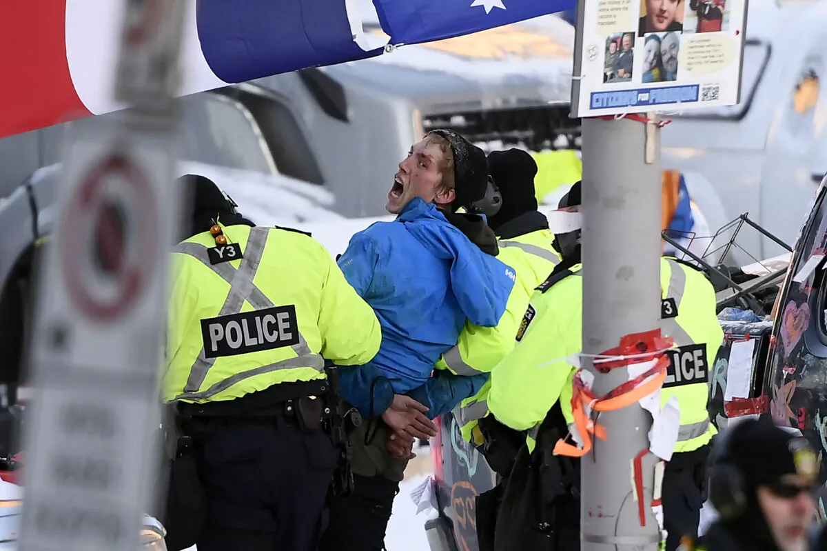 A protester is arrested by police in Ottawa on Feb. 18, 2022. (Justin Tang/The Canadian Press)