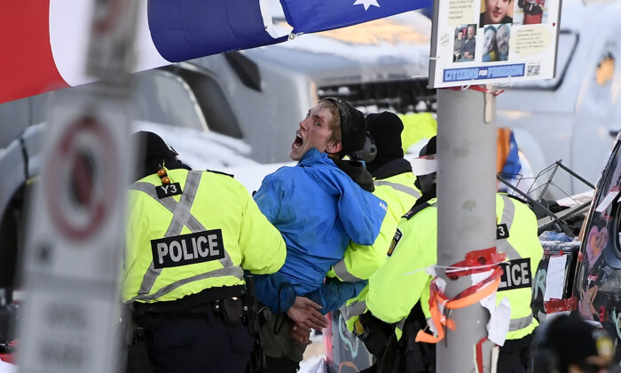A protester is arrested by police in Ottawa on Feb. 18, 2022. (Justin Tang/The Canadian Press)