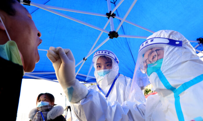 A resident is swabbed for a nucleic acid test for COVID-19 in Lianyungang, in eastern China's Jiangsu Province on Feb. 18, 2022. (STR/AFP via Getty Images)