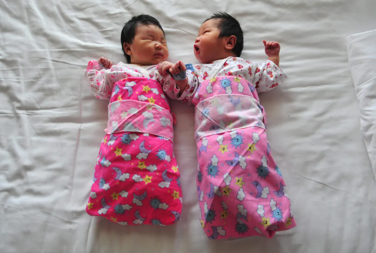 Newborn babies lie on a hospital bed in Beijing, China, on Dec. 1, 2008. (Frederic J. Brown/AFP via Getty Images)