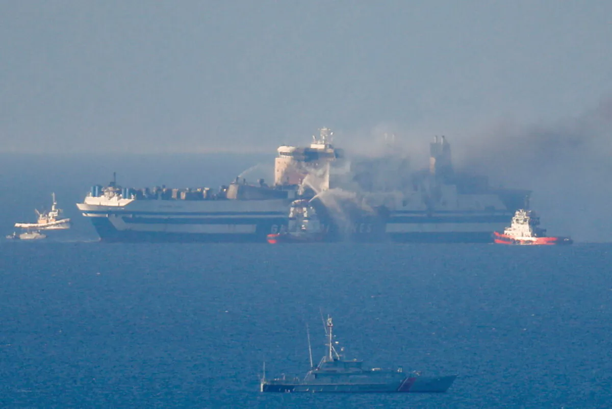 Smoke on the Italian-flagged Euroferry Olympia, which sailed from Greece to Italy early on Friday and caught fire, is seen from Himara, Albania, on Feb. 19, 2022. (Florion Goga/Reuters)