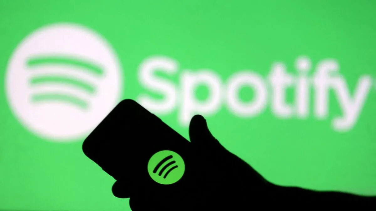 A smartphone in front of a screen projection of the Spotify logo taken on April 1, 2018. (Dado Ruvic/Illustration/Reuters)