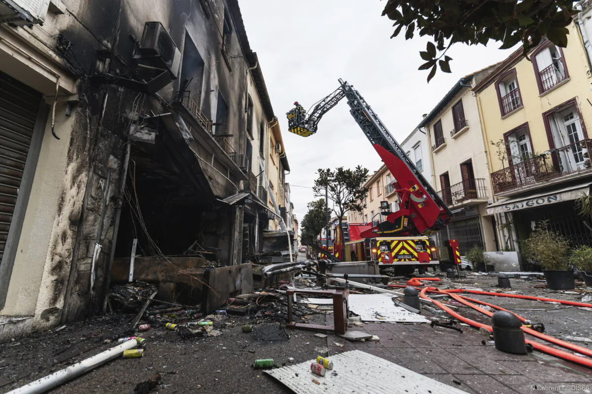 A fireworker works at apartment buildings after a fire in Saint-Laurent-de-la-Salanque, southern France, on Feb.14, 2022. (SDIS66 via AP)