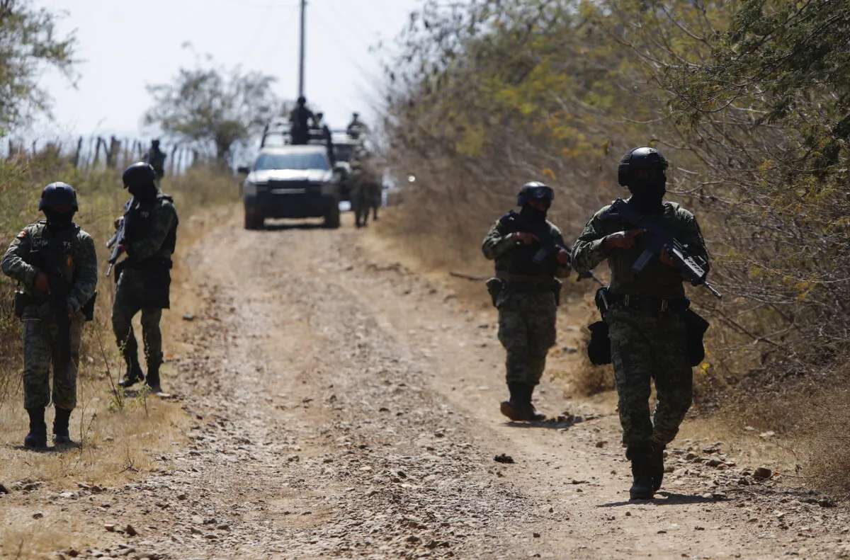 Members of the Mexican army patrol near Naranjo de Chila in the municipality of Aguililla, Mexico, on Feb. 18, 2022. The town had been the scene of a bloody turf battle between two drug cartels. (Armando Solis/AP Photo)